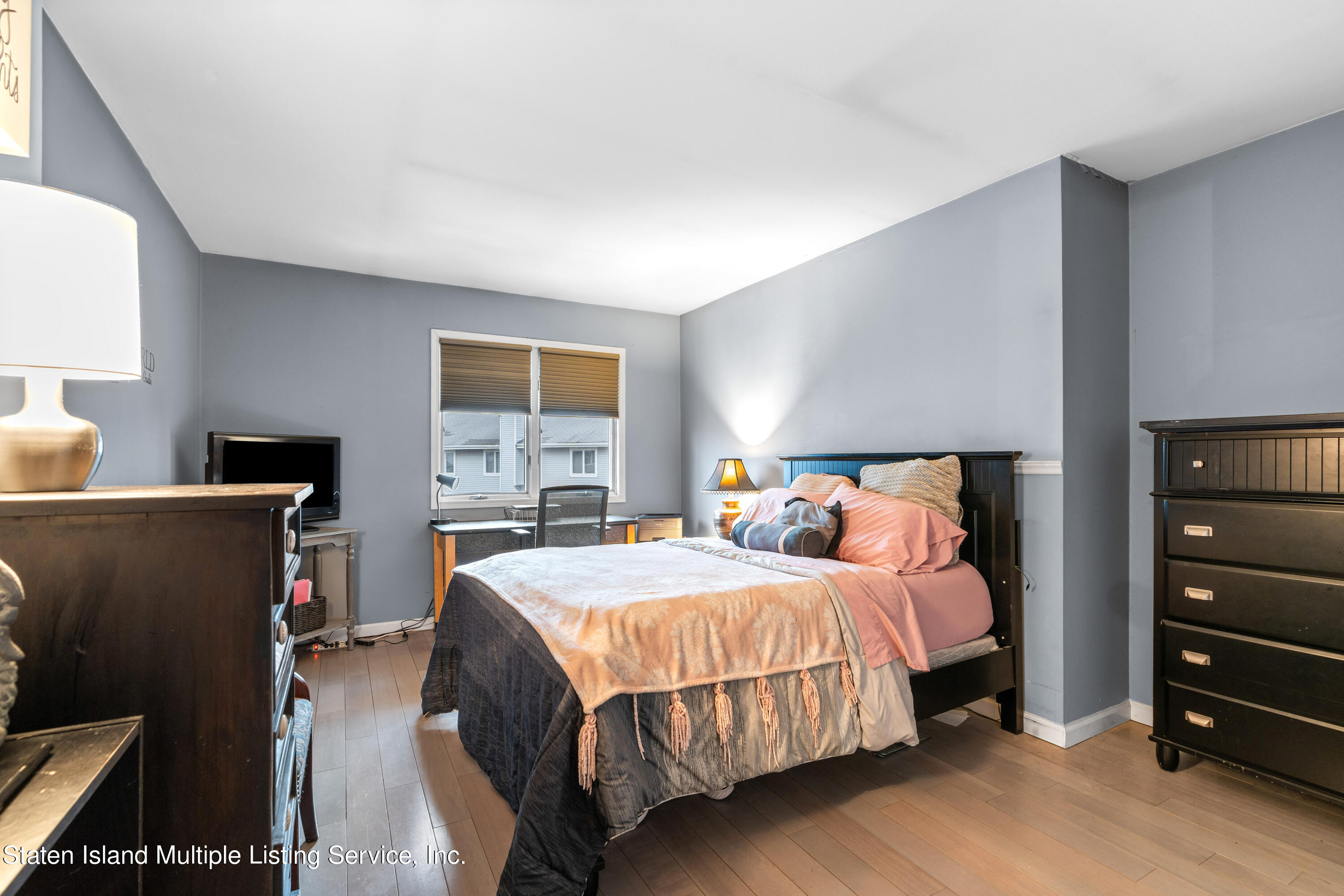 15 Flagship Circle Staten Island, NY 10309 - Photo 26 of 31 a bedroom with a bed and a flat tv screen on dresser