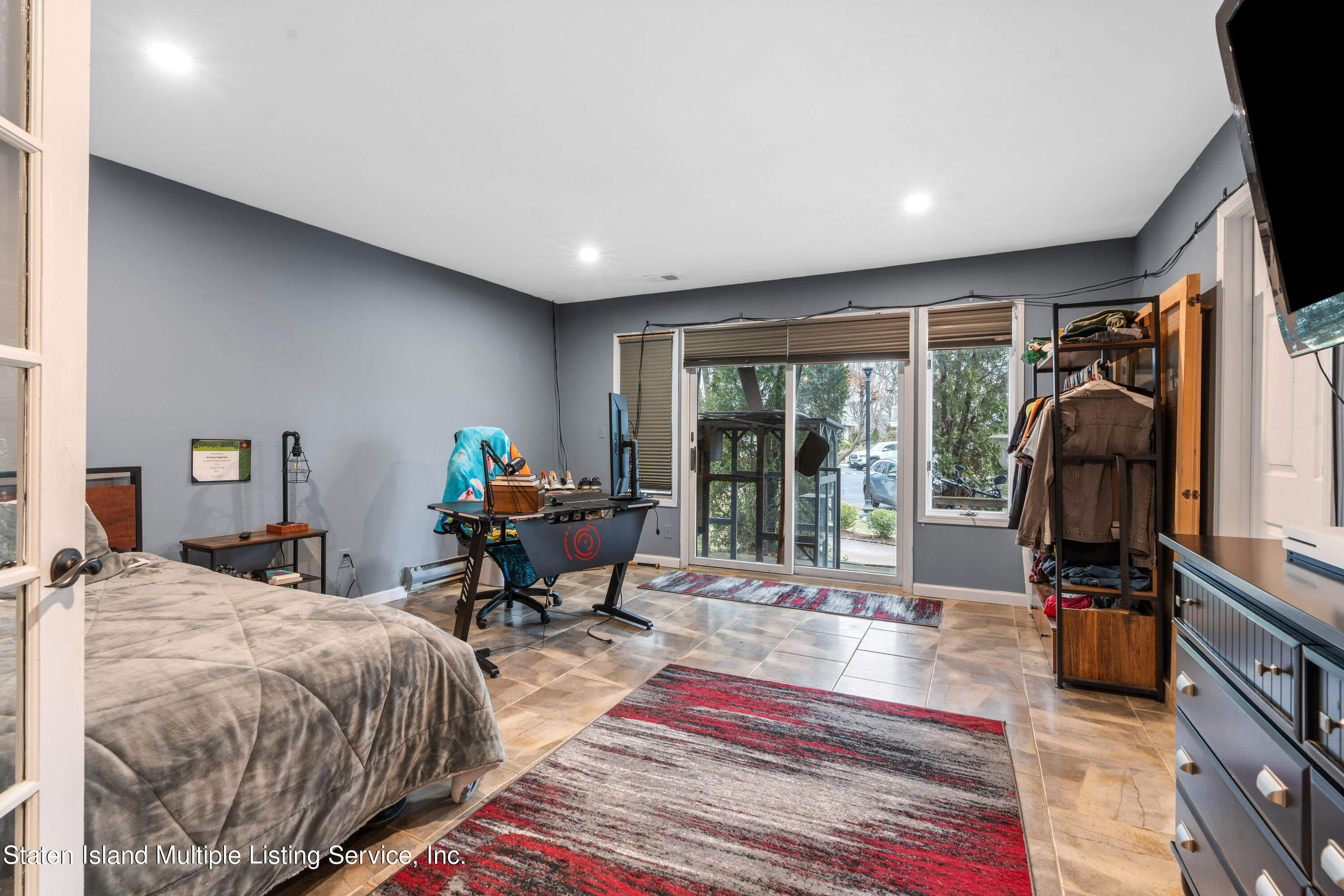 15 Flagship Circle Staten Island, NY 10309 - Photo 6 of 31 a bedroom with a bed a large window and walk in closet