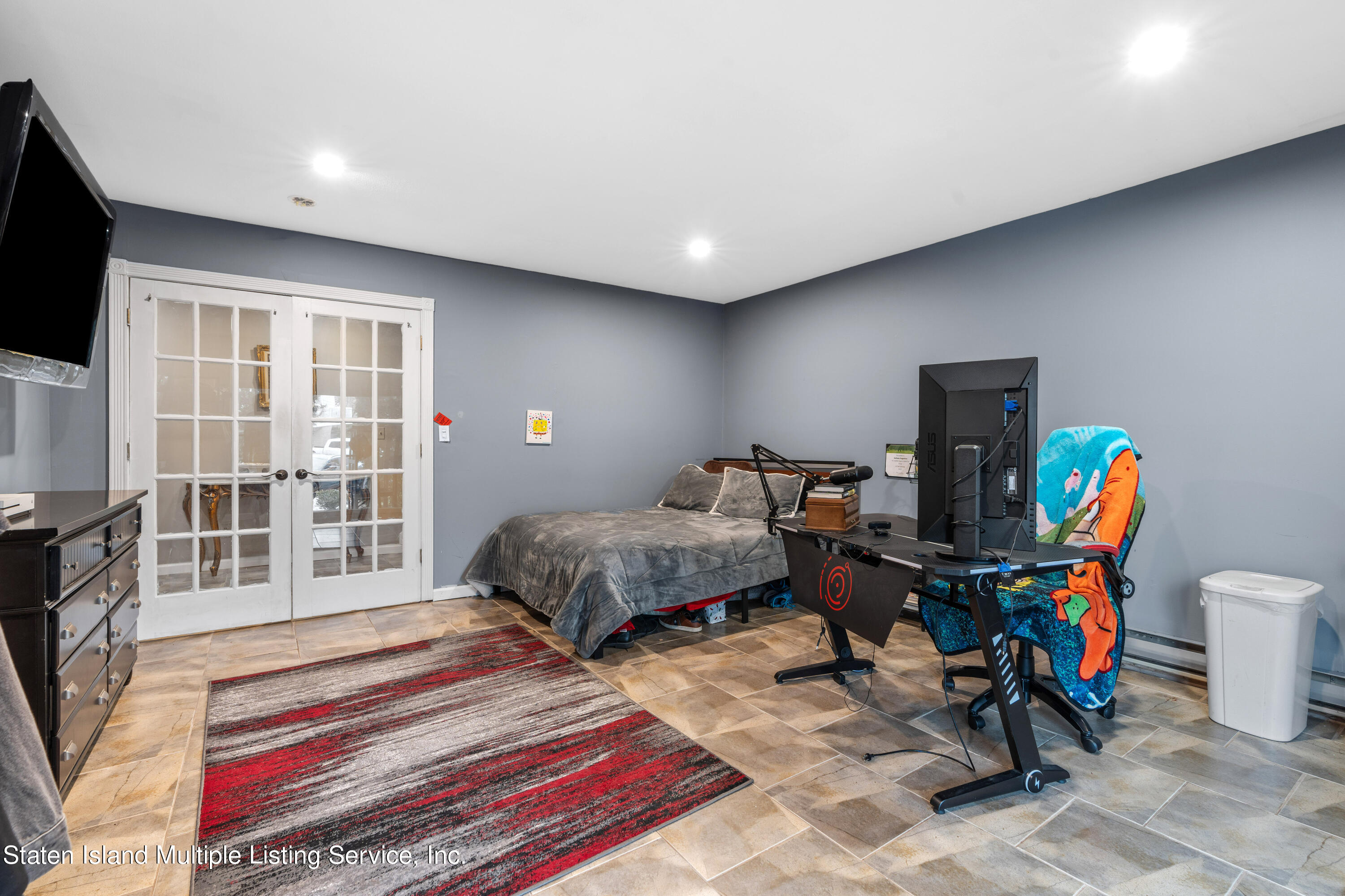 15 Flagship Circle Staten Island, NY 10309 - Photo 7 of 31 a bedroom with a bed a flat screen tv and a large window with the outer view