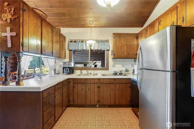 a kitchen with a sink appliances and cabinets