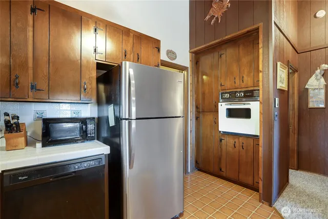 a kitchen with a refrigerator and a sink