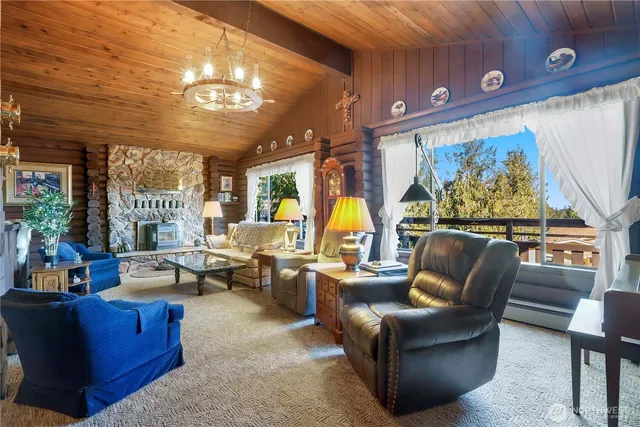 a living room with furniture a large window and a projector