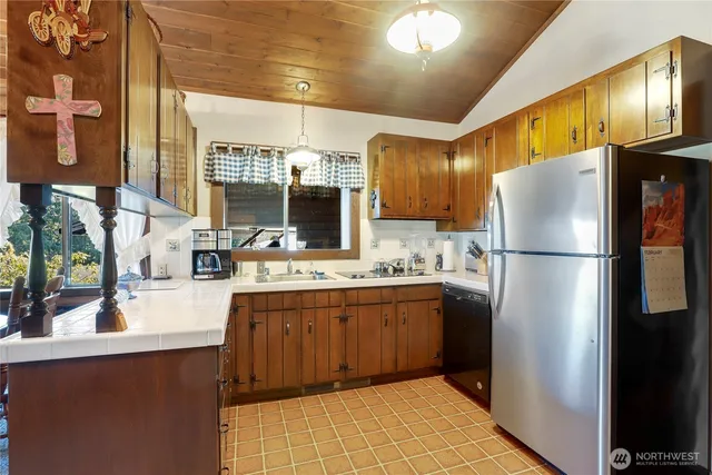 a kitchen with stainless steel appliances granite countertop a refrigerator and a sink