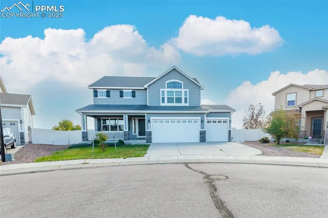 an aerial view of a house with a big yard and large trees