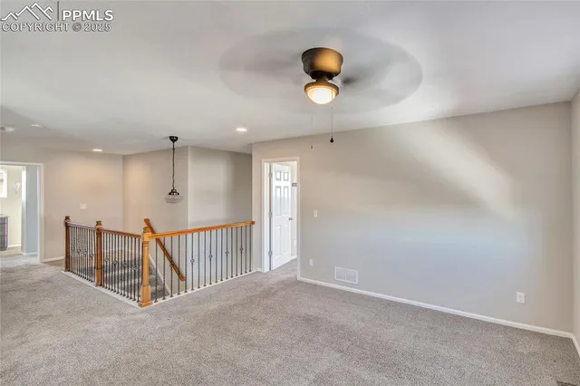 a view of an empty room with a ceiling fan