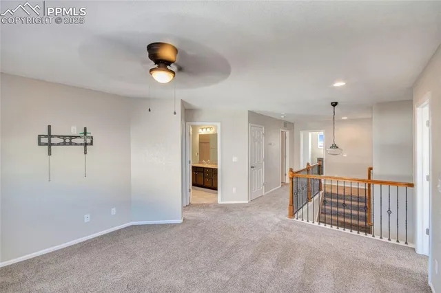 a view of staircase with railing and a rug