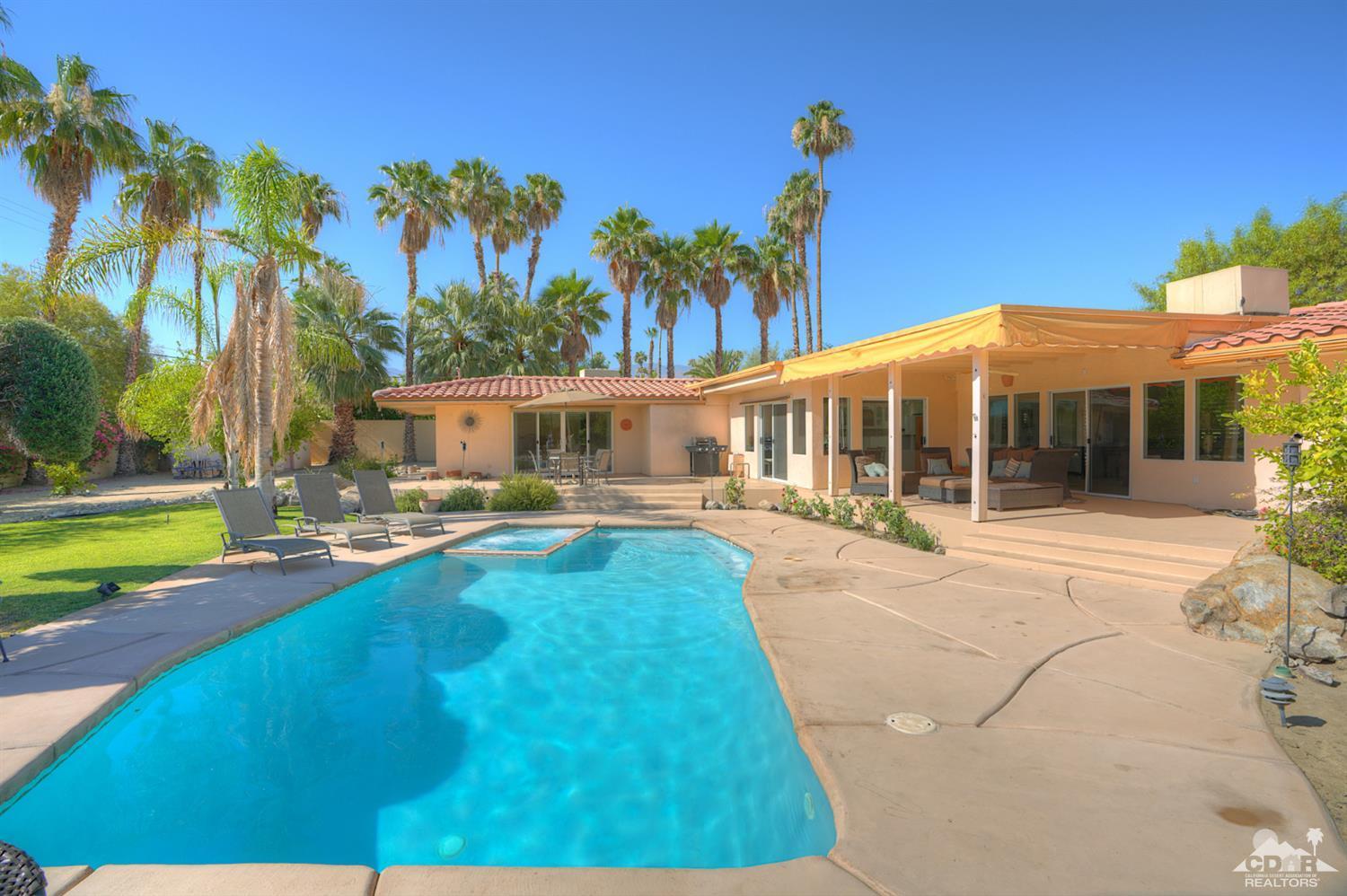 72983 Joshua Tree Street Palm Desert, CA 92260 - Photo 1 of 42 a view of a house with swimming pool and a yard