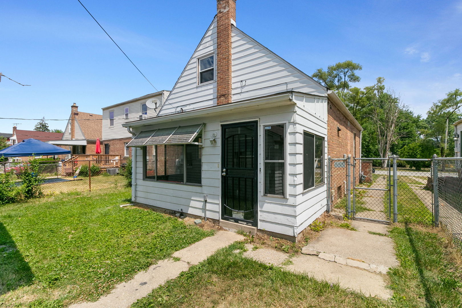 1532 State Line Road Calumet City, IL 60409 - Photo 15 of 15 a view of a house with a small yard and sitting area