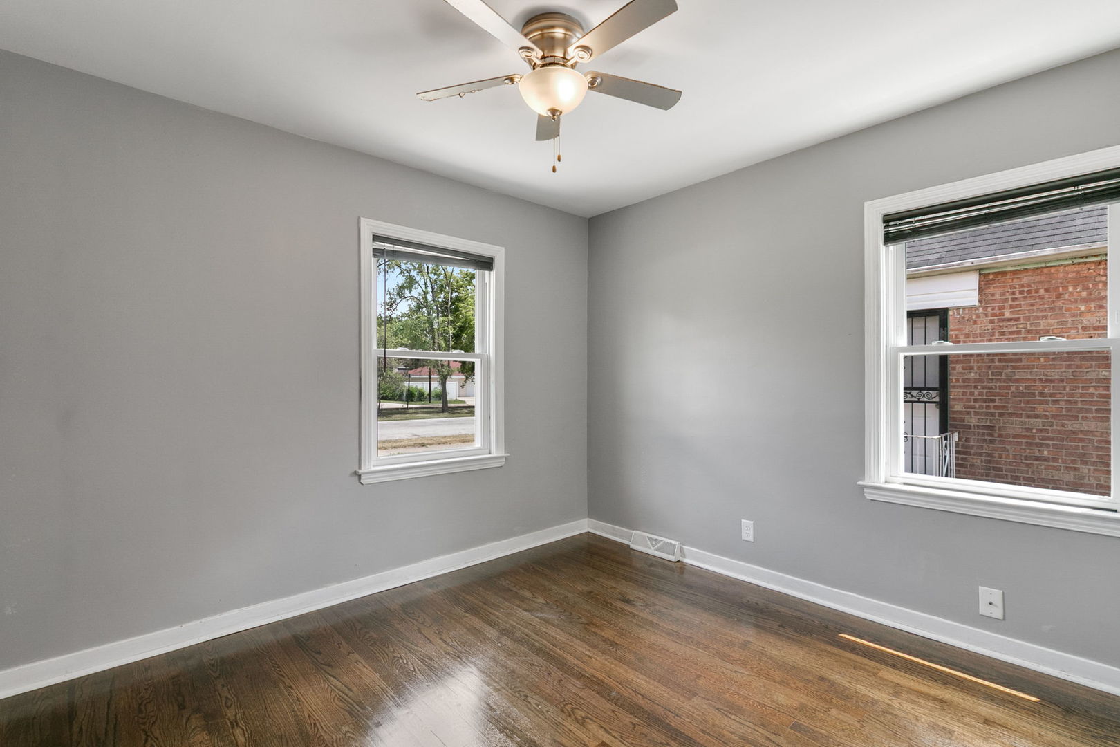 1532 State Line Road Calumet City, IL 60409 - Photo 3 of 15 a view of an empty room with wooden floor and a window