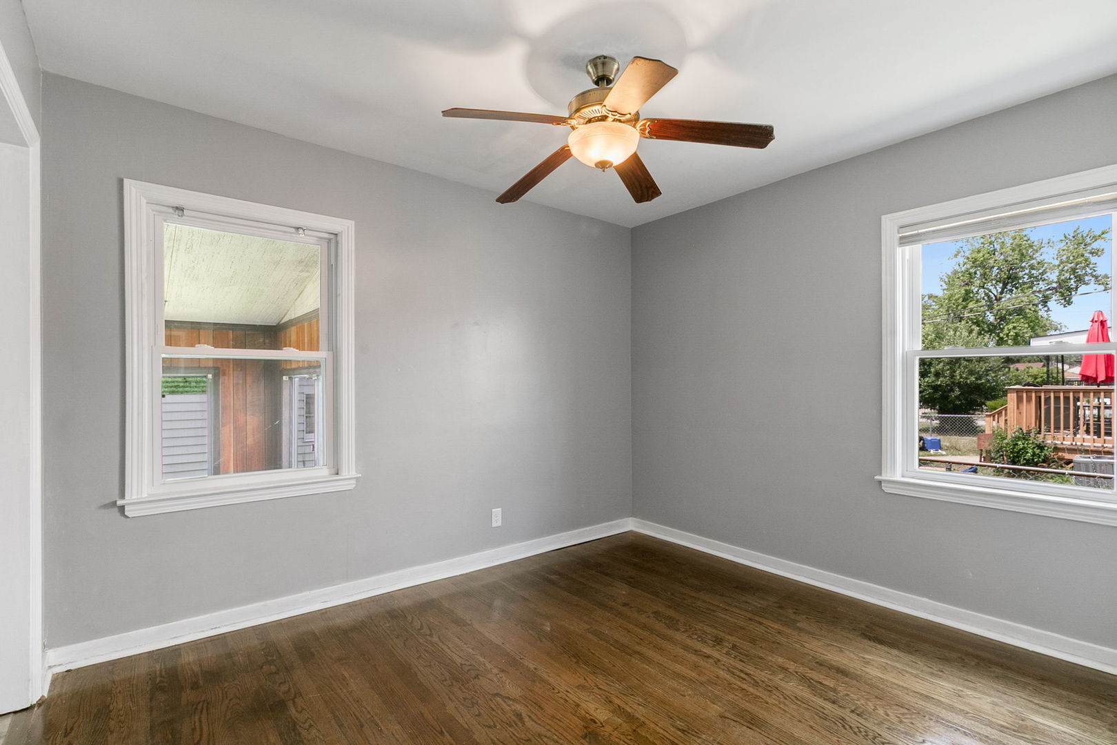 1532 State Line Road Calumet City, IL 60409 - Photo 5 of 15 a view of an empty room with wooden floor and a window