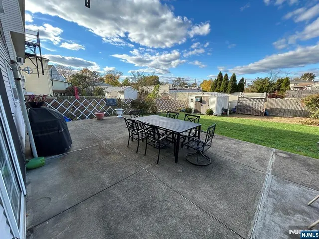 a view of a patio with a table and chairs