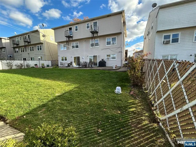 a view of a house with a backyard