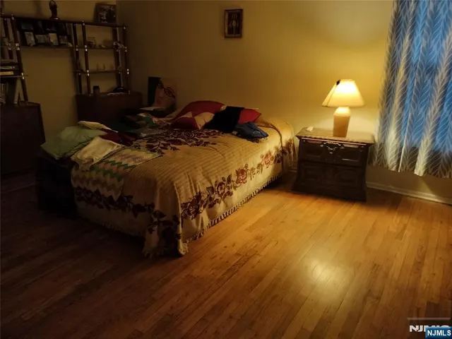 a bed sitting in a bedroom next to a lamp