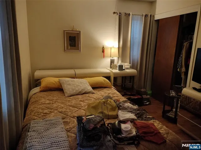 a bed sitting in a bedroom next to a window