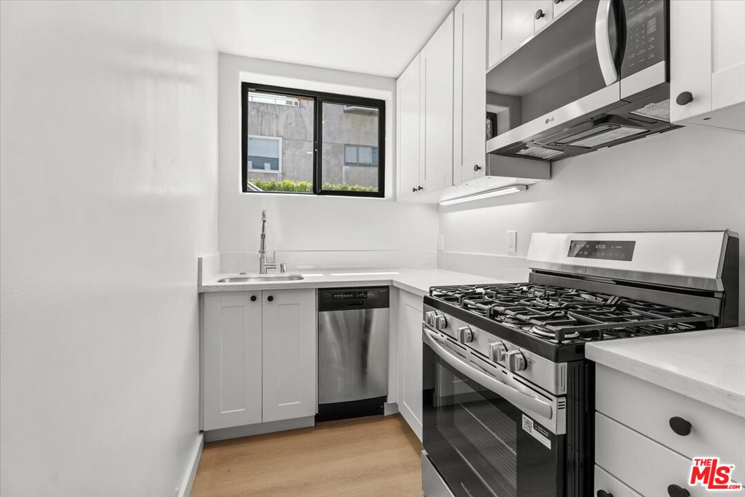 6732 Esplanade Street Playa del Rey, CA 90293 - Photo 3 of 10 a kitchen with stainless steel appliances granite countertop a stove and a sink
