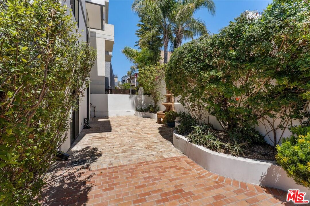 6732 Esplanade Street Playa del Rey, CA 90293 - Photo 9 of 10 a view of a backyard with potted plants and large trees