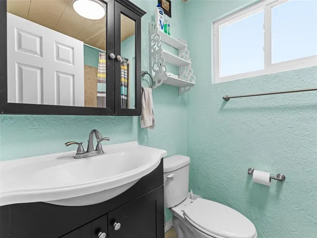 a bathroom with a sink a mirror and a toilet