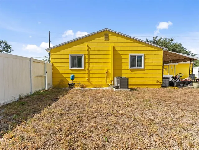 a view of swimming pool with tree in front of it