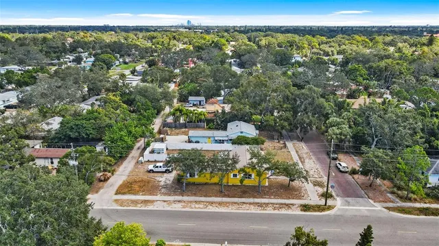 an aerial view of a house with a yard and fountain in front of it