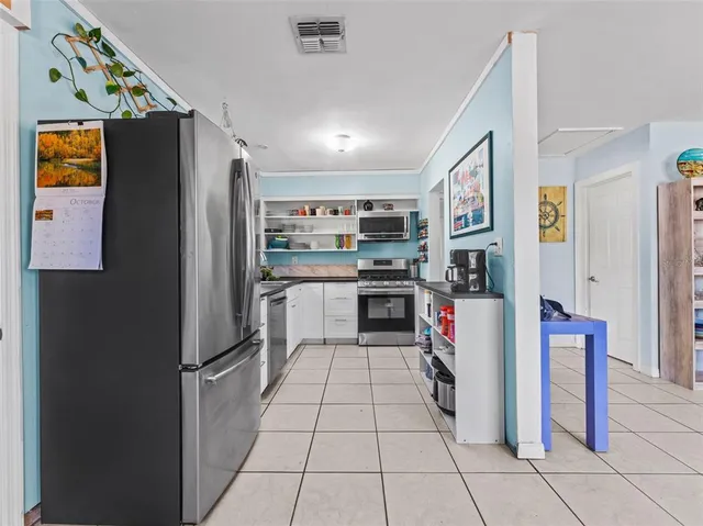 a kitchen with stainless steel appliances a refrigerator and a stove