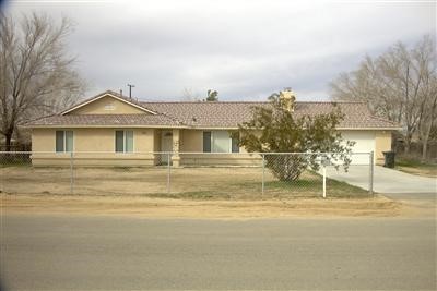 13010 Clallam Road Apple Valley, CA 92308 - Photo 1 of 1 a house with trees in front of it