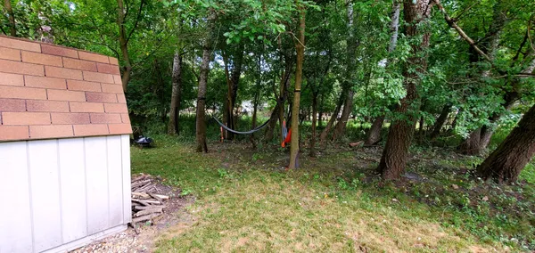 a backyard of a house with chairs and table