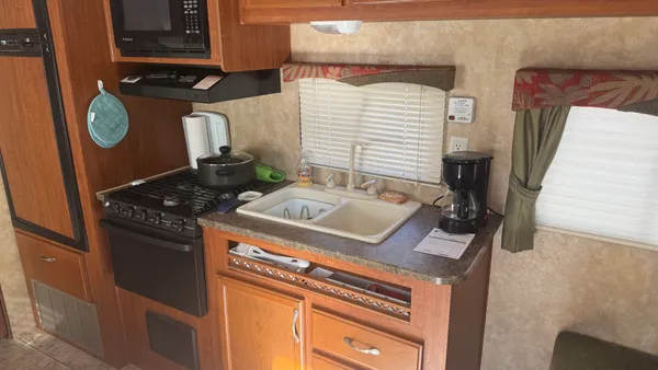 a kitchen with a stove and a refrigerator
