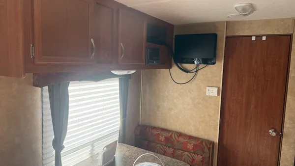 a bathroom with a glass shower door and a window