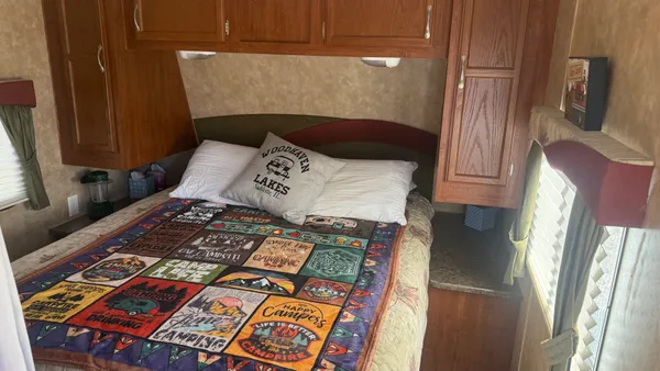 a bed sitting in a bedroom next to a window