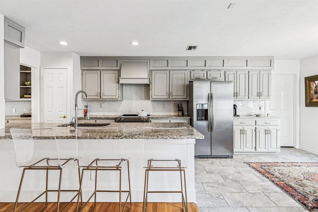 3635 Bryan Street Dallas, TX 75204 - Photo 15 of 40 a kitchen with stainless steel appliances granite countertop a stove a sink and a refrigerator