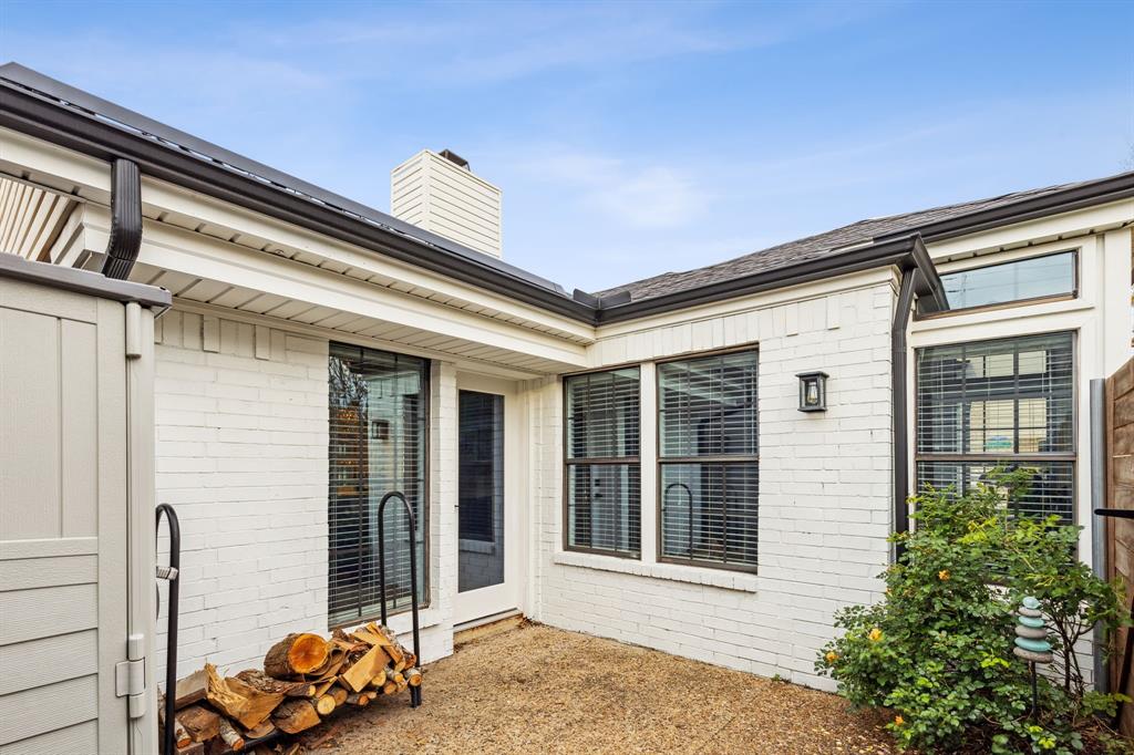 3635 Bryan Street Dallas, TX 75204 - Photo 33 of 40 a front view of a house with a large window and potted plants