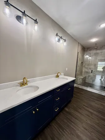 a spacious bathroom with a double vanity sink and a mirror
