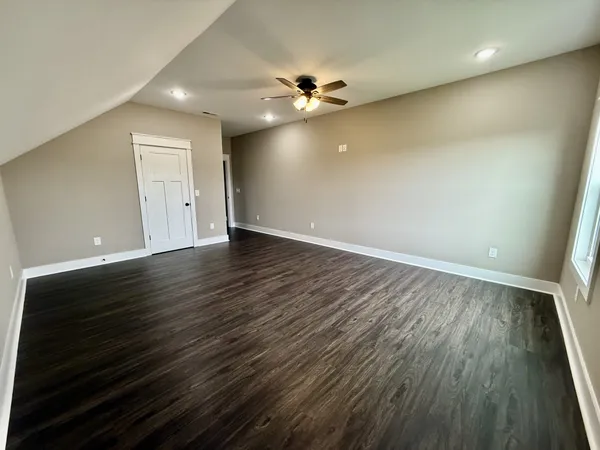 a view of a room with wooden floor