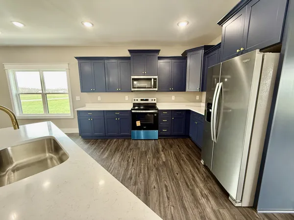 a kitchen with wooden cabinets and stainless steel appliances