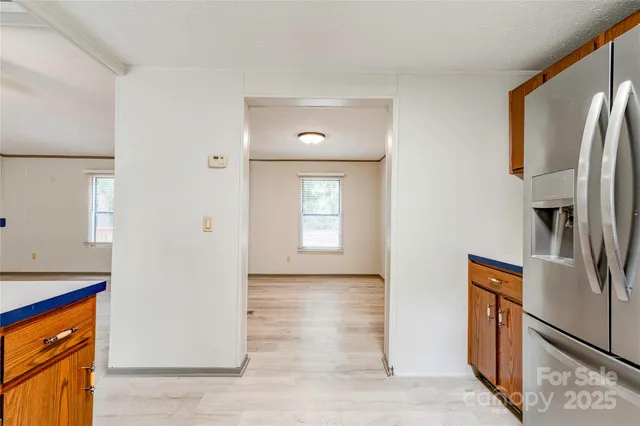 a view of a kitchen with a refrigerator cabinet and a window