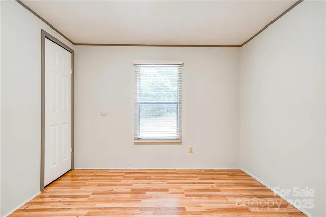 a view of a room with wooden floor and windows