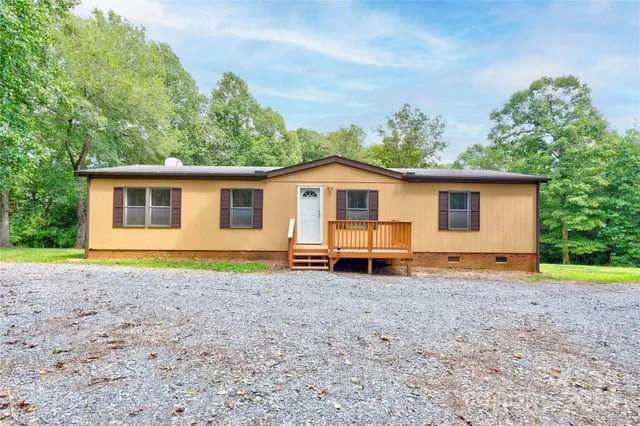 a view of a house with a yard and sitting area