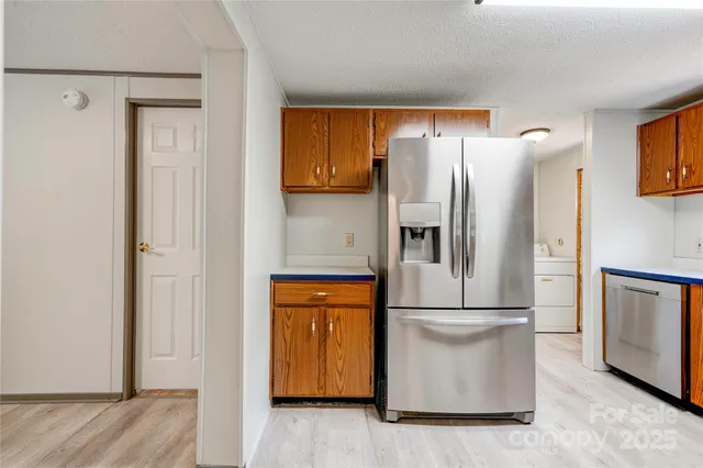 a metallic refrigerator freezer sitting in a kitchen