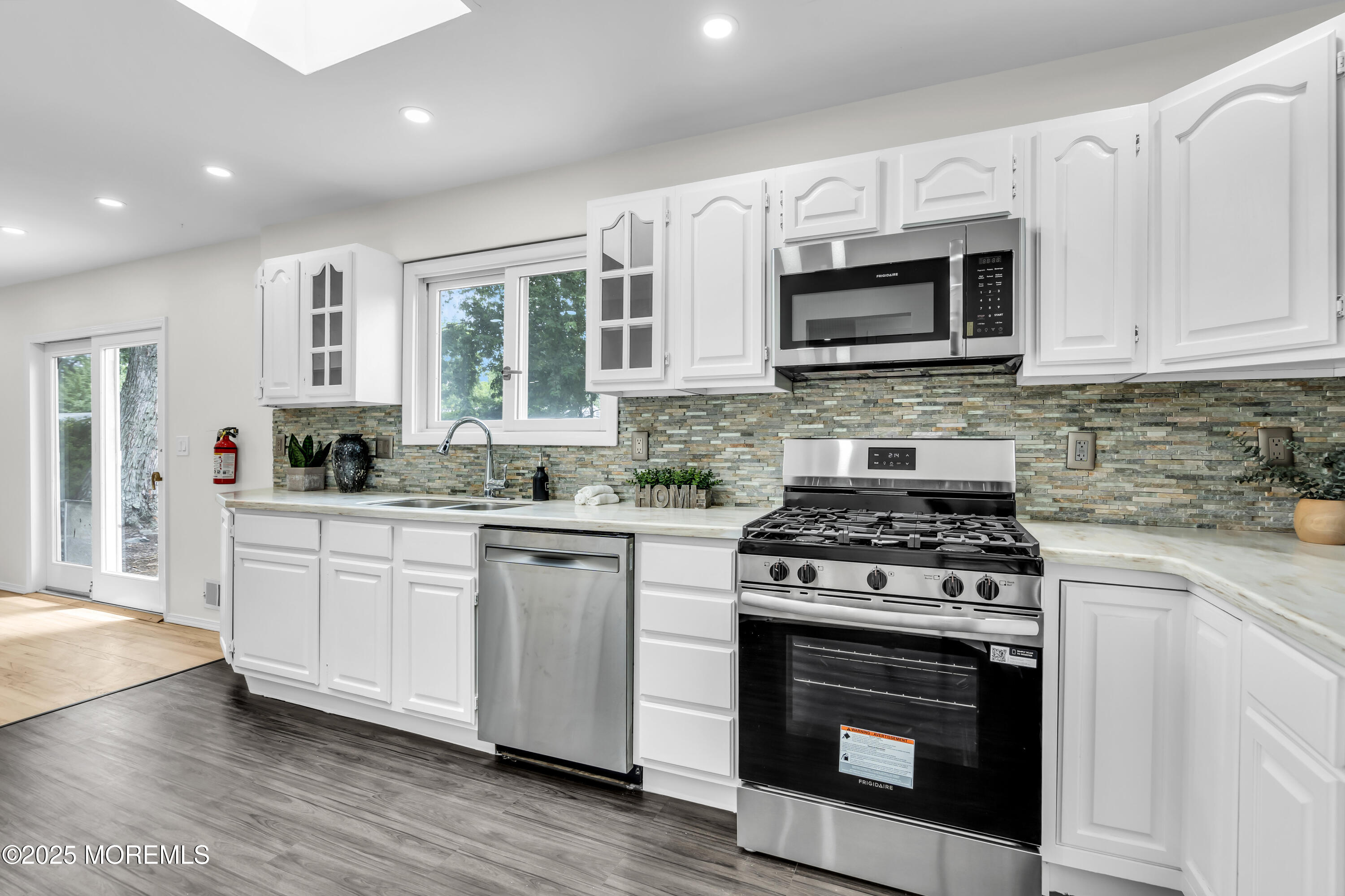 832 7th Avenue Toms River, NJ 08757 - Photo 12 of 31 a kitchen with stainless steel appliances granite countertop a stove top oven a sink dishwasher a refrigerator and a microwave