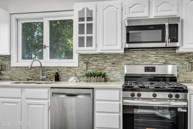 a kitchen with stainless steel appliances granite countertop a stove and a sink