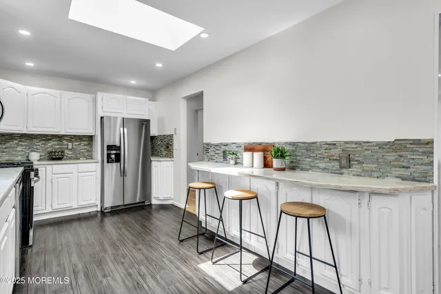 a kitchen with stainless steel appliances a refrigerator and wooden cabinets