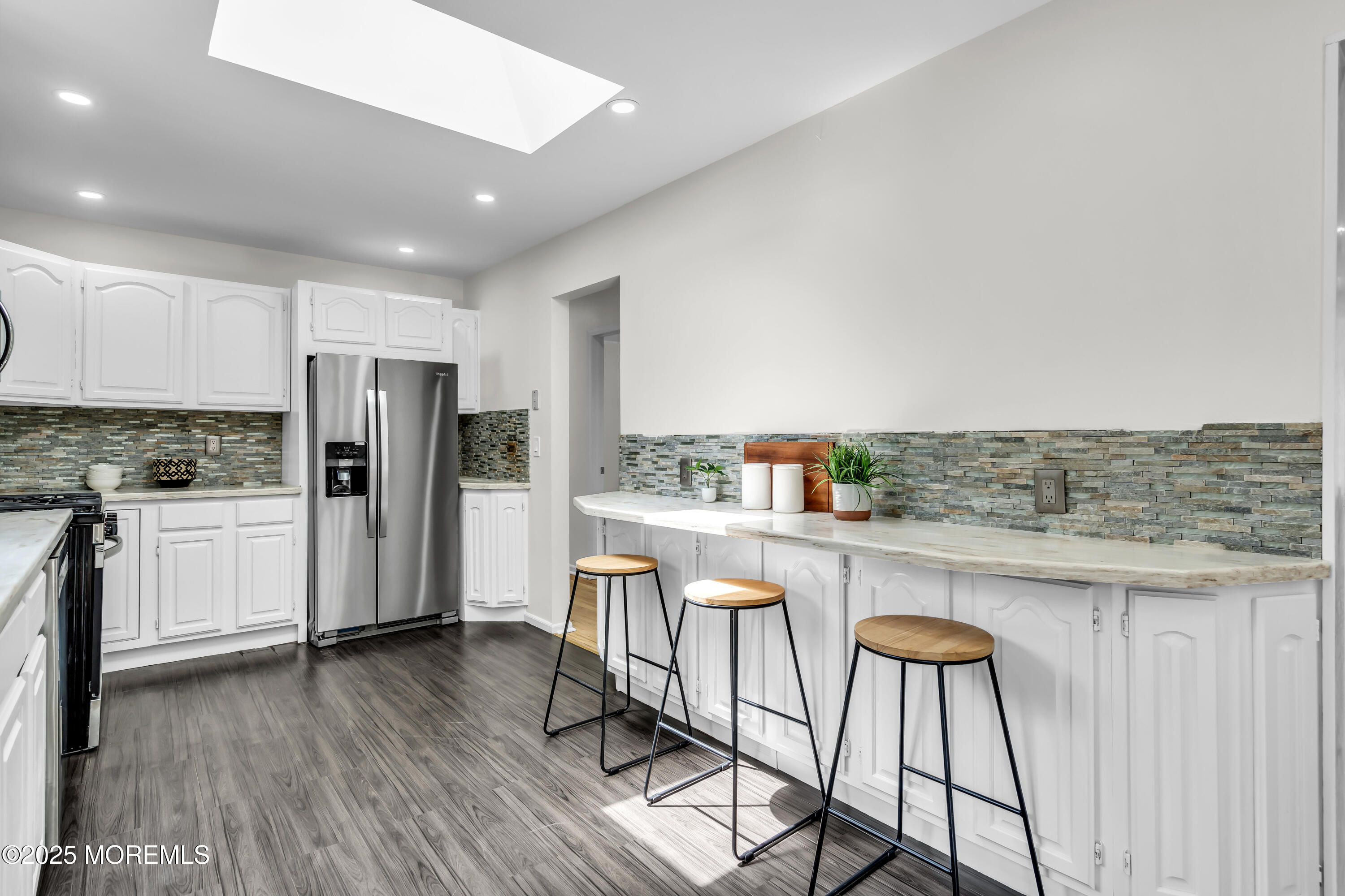 832 7th Avenue Toms River, NJ 08757 - Photo 14 of 31 a kitchen with stainless steel appliances a refrigerator and wooden cabinets