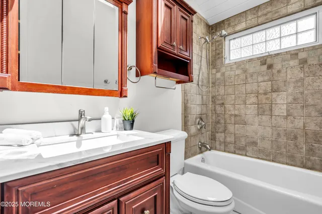 a bathroom with a sink a toilet and bathtub