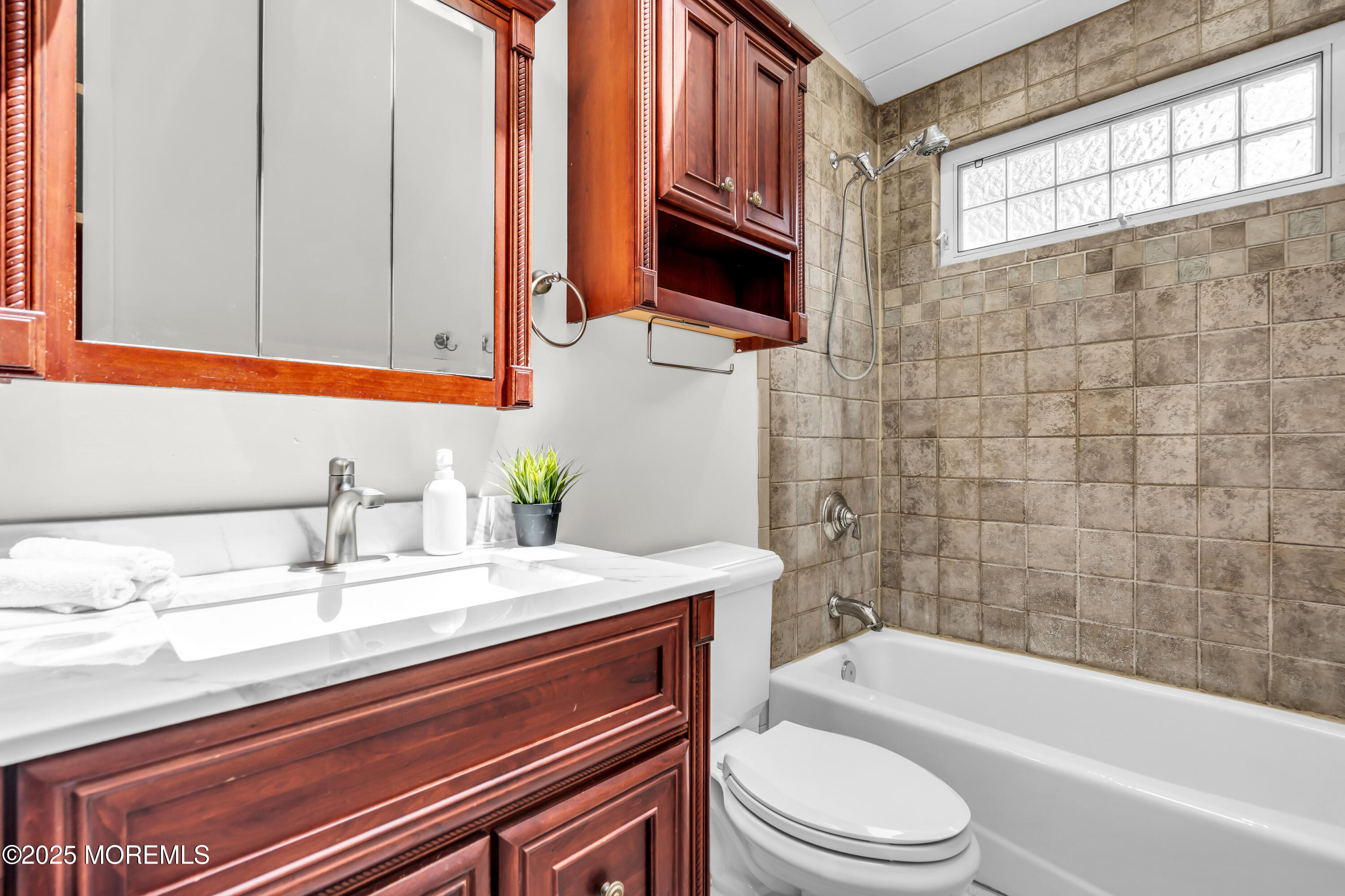 832 7th Avenue Toms River, NJ 08757 - Photo 18 of 31 a bathroom with a sink a toilet and bathtub