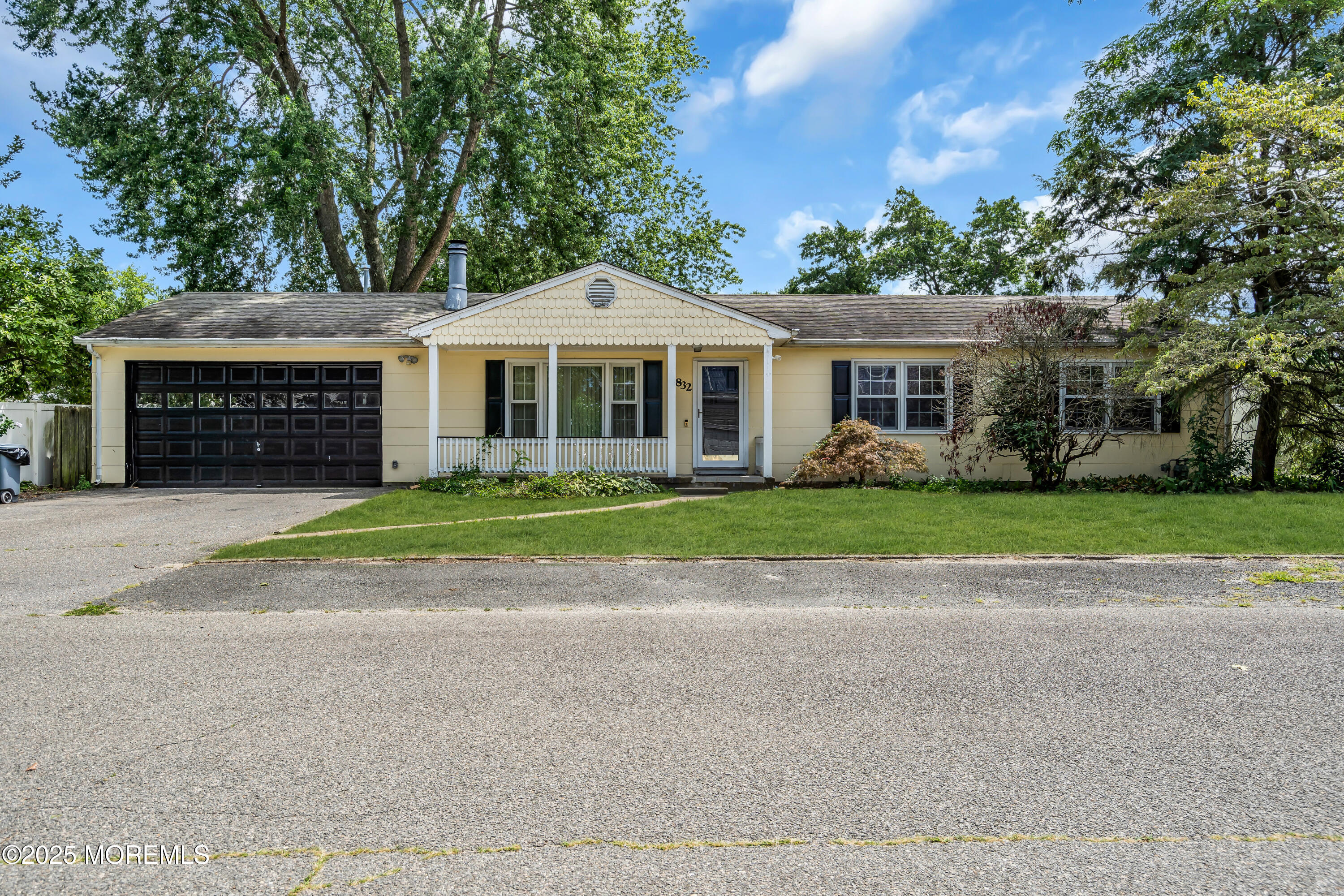 832 7th Avenue Toms River, NJ 08757 - Photo 2 of 31 a front view of a house with a garden and trees