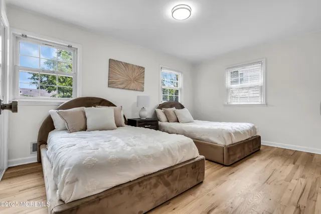 a bedroom with two beds and a window