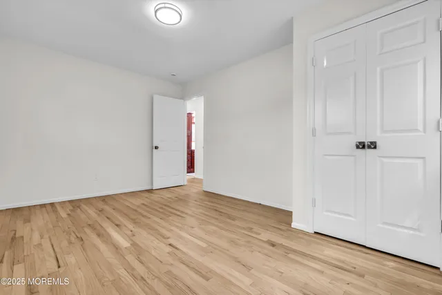 a view of an empty room and wooden floor