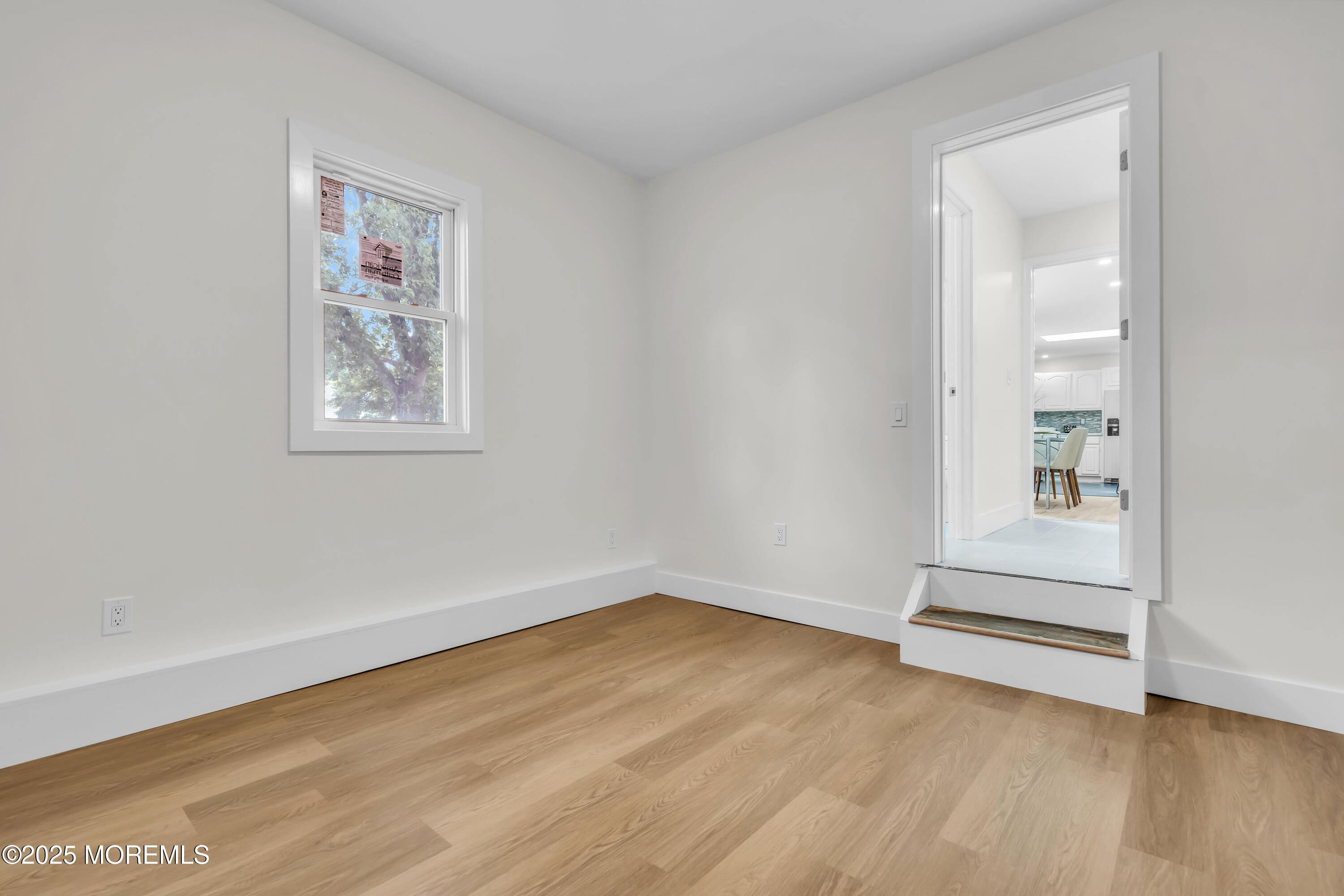 832 7th Avenue Toms River, NJ 08757 - Photo 25 of 31 an empty room with wooden floor and window