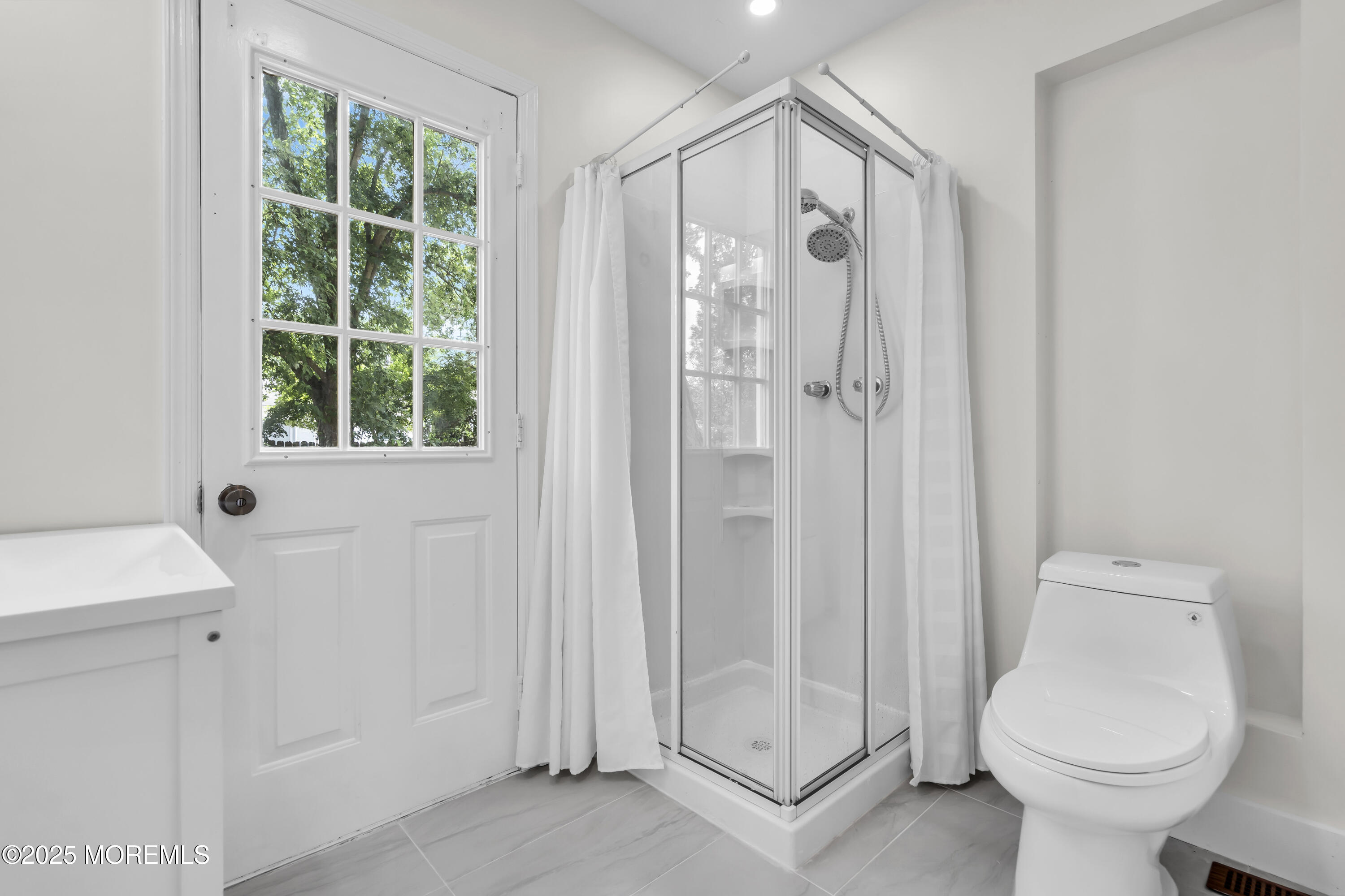 832 7th Avenue Toms River, NJ 08757 - Photo 28 of 31 a bathroom with a shower a toilet and a sink