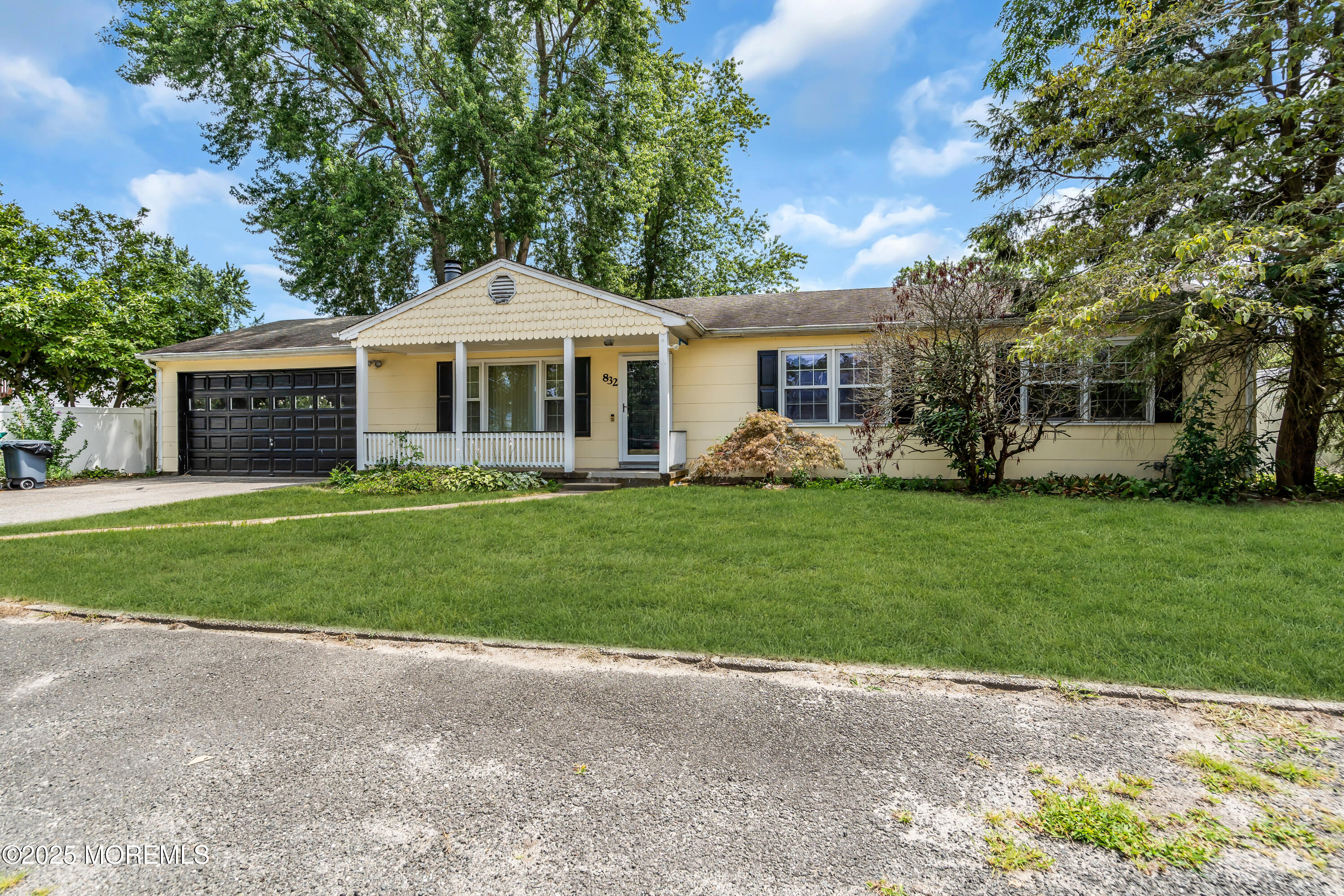832 7th Avenue Toms River, NJ 08757 - Photo 3 of 31 a front view of a house with a garden and trees